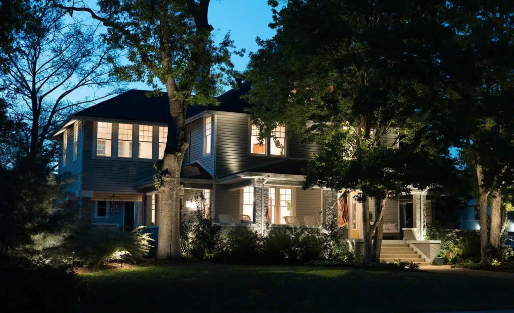 Elegant home at dusk showcasing outdoor lighting. Soft light illuminates the facade, highlighting the architecture and landscaping, creating a warm and inviting ambiance.